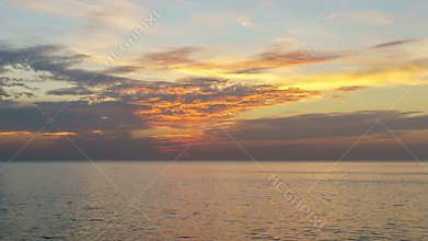4K/UHD Day to Night Time-lapse : Timelapse of clouds crossing the amazing sky over the sea or ocean at sunset.