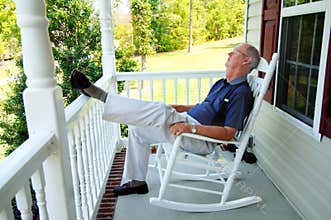 Senior man naps on front porch