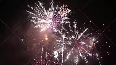Bright colorful fireworks on new years eve in Ostrava, Czech republic against cloudy sky, no audio