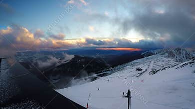 Fast running clouds over Low Tatras with magic sunset. Chopok mountain 2024 meters