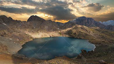 Mountain lake with reflection on the smooth water, timelapse of from day to nigh