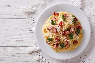 Italian food: pasta carbonara on the table. horizontal top view