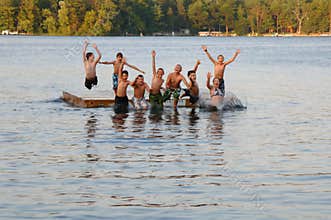 Group of kids jumping into Lake