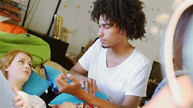 Three teenage mixed race communicate