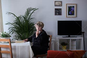 Bereaved woman alone at home