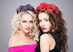 Beautiful, sensual blond and brunette wearing flower alike coronets