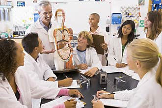School children and their teacher in science class