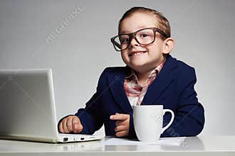 Young business boy. smiling child in glasses. little boss in office