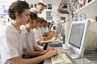 Row of schoolchildren studying on computer