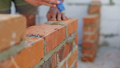 Work lays bricks on a construction site