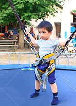 Boy on the bungee trempoline