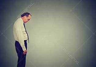 Sad lonely business man looking down has no energy motivation in life depressed