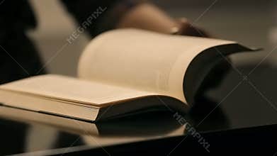 Woman hand leafing book pages