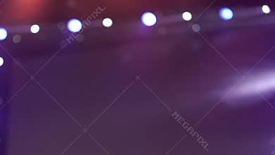 Spotlight strike through the darkness on stage. Stage lights. Several projectors in the dark.