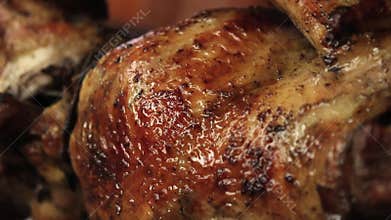 Roasted chicken grilled on fire, barbeque. In South America called pollo a la brasa.