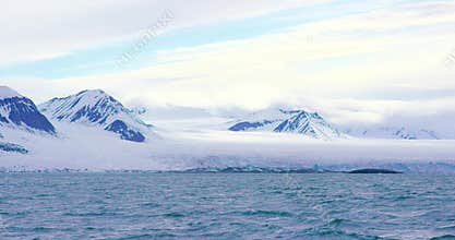 Mountains and a massive glacier in the arctic