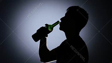 Drunk man drinking wine. Back light. Close up