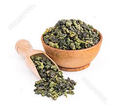 Tieguanyin oolong green tea in a wooden bowl isolated on white
