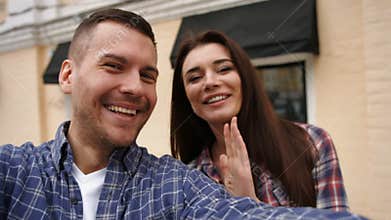 Two adorable people in love feeling happy to be together and taking selfies to remember this time forever .