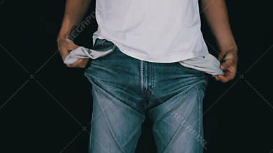 Man Turns the Empty Pockets of His Jeans. No Money