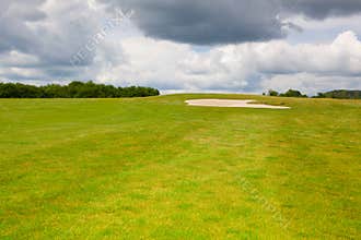 Sand golf bunker on a empty golf course before rain