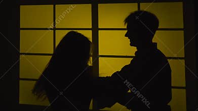 Strained relationship. Quarrel with a slap. Silhouette. Slow motion. Close up