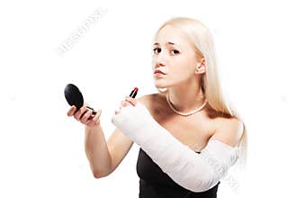 Girl with a broken arm trying to put makeup