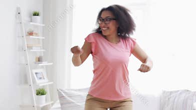 Happy african american young woman dancing at home