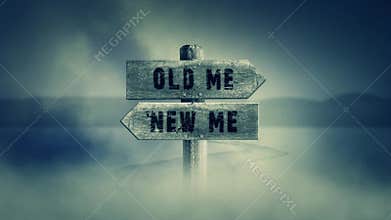 Old Wooden Sign on a Middle of a Cross Road With the Words Old Me or New Me