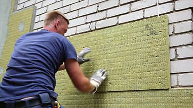 House insulation - insulating house facade with mineral rock wool