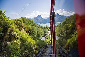 An old steam locomotive is climbing up the'schafbergbahn' on to the top of the Schafberg