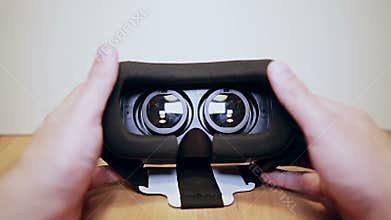 Virtual reality glasses, vr on the table, mans hands take them and wears