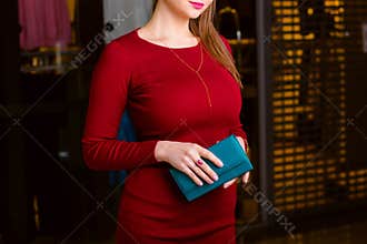 Respectable woman holding wallet.