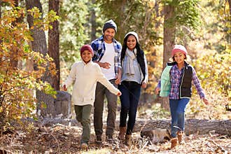 African American Family Walking Through Fall Woodland