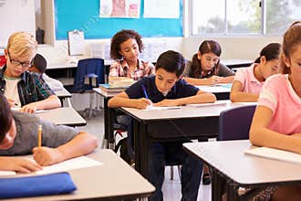 Elementary school kids working at their desks in a classroom
