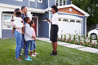 Real estate agent showing a family a house