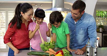 A happy family is cooking together