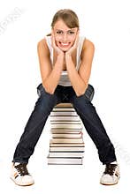 Woman sitting on stack of books
