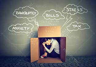 Worried woman hiding from stress inside box