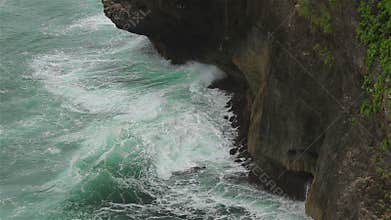 A rocky cliff and ocean waves