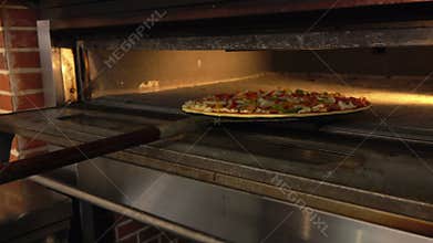 Pizza is placed in the oven