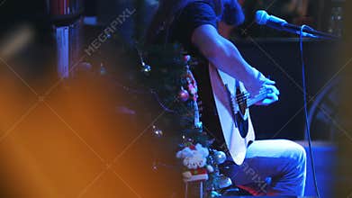 Bearded guitarist at concert - acoustic guitar, microphone, club