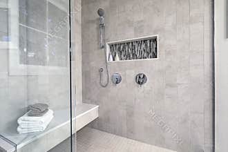 Glass walk-in shower in a bathroom of brand new home
