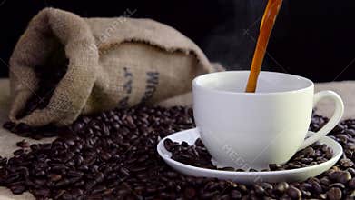Pouring fresh tasty coffee into cup