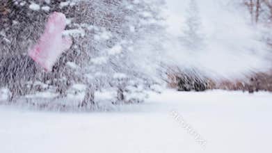 Happy friends playing with snow in winter