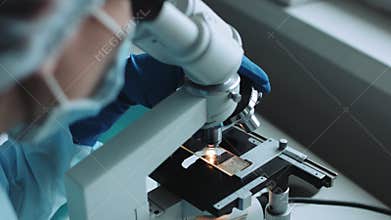 Scientist working in laboratory with microscope