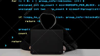 Hacker in black hood with a laptop