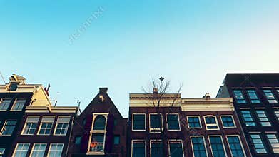 Slow motion video of view from the canal to the streets, canals with old flamish houses and bridges in Amsterdam