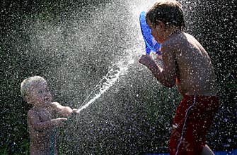 Brothers playing with water