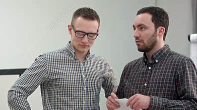 Two businessmen tearing up a document or contract